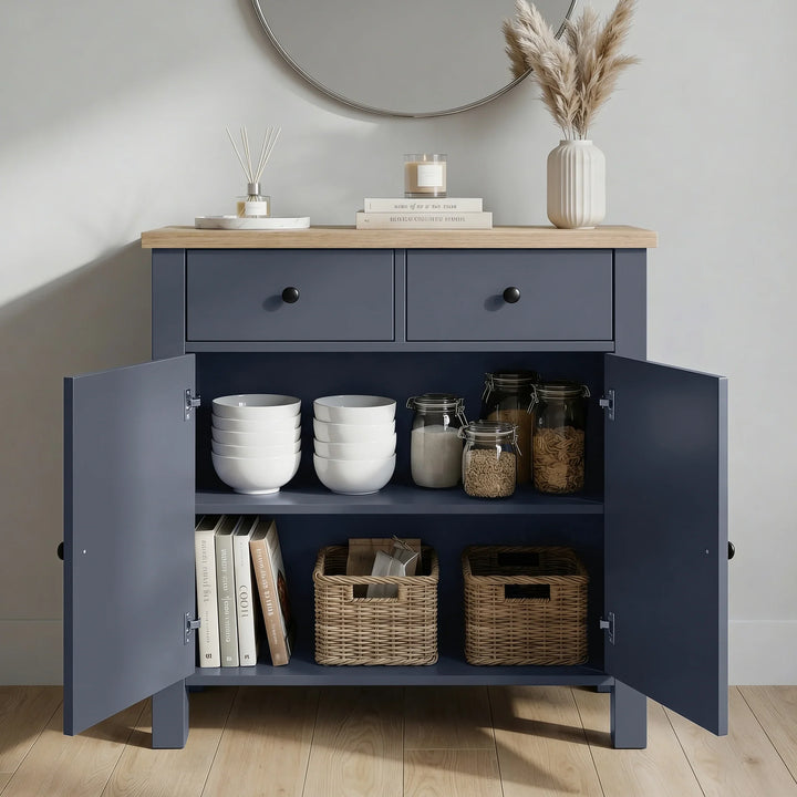 [Blue] cabinet with open doors displaying white bowls, jars, and books against a neutral wall