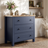 [Blue] Linra chest of drawers side view styled with pots, planter, books and floral vase on oak veneer top