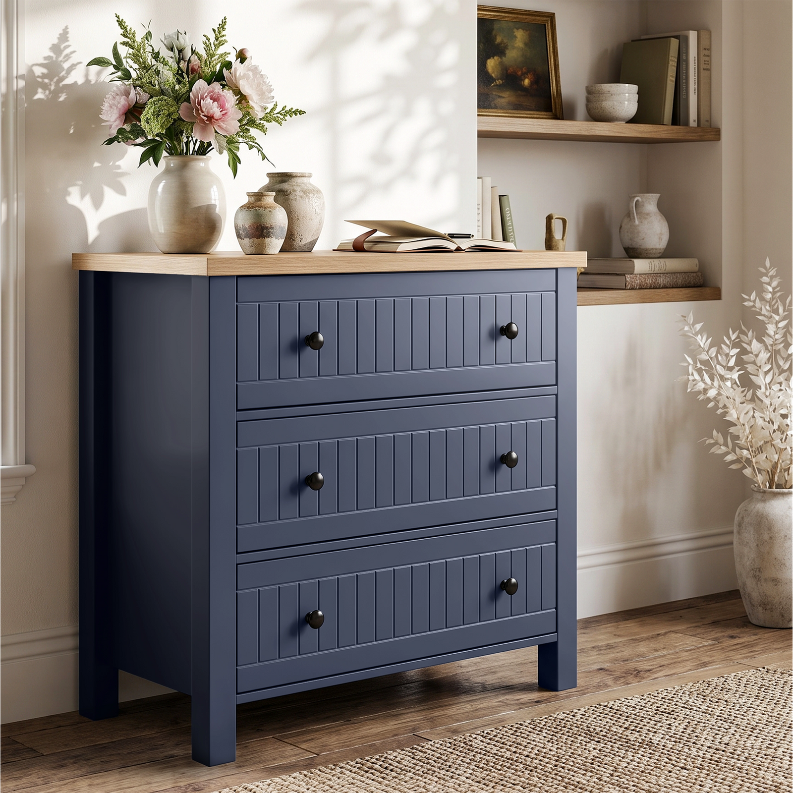 [Blue] Linra chest of drawers side view styled with pots, planter, books and floral vase on oak veneer top