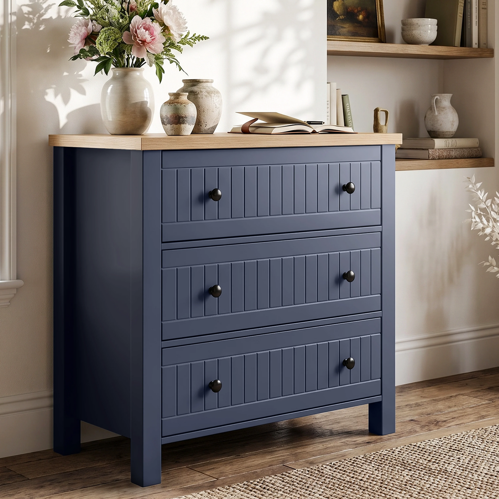 [Blue] Linra chest of drawers side view styled with pots, planter, books and floral vase on oak veneer top
