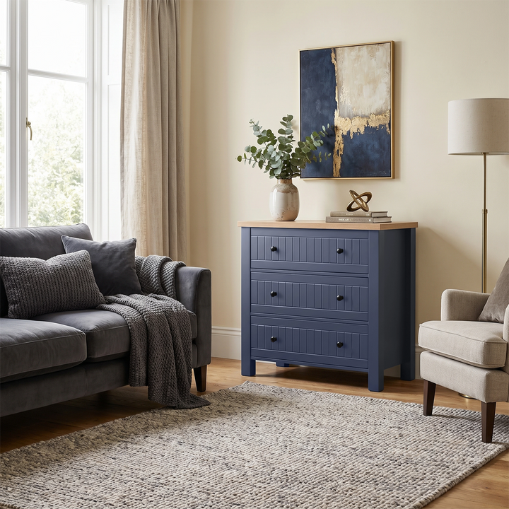 [Blue] Linra chest of drawers angled lifestyle view in living room with sofa set, rug and wall art with floor lamp