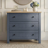 [Blue] Linra chest of drawers in panelled hallway beneath round wood-framed mirror with hydrangeas