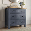 [Blue] Linra chest of drawers front view styled with clock, books and floral vase on oak veneer top