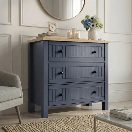 [Blue] Linra chest of drawers angled lifestyle view in living room with armchair, rug and round mirror