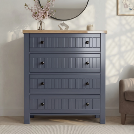 [Blue] Linra 4-drawer chest front view in a styled room with round mirror, vase and accessories on oak veneer top