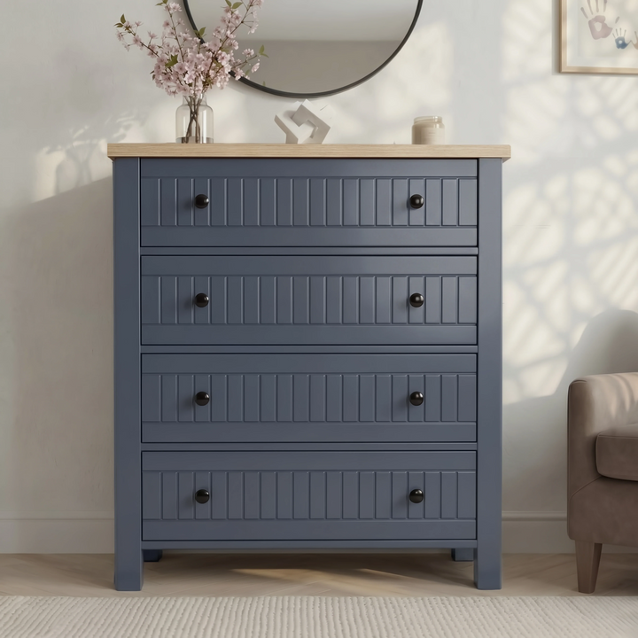 [Blue] Linra 4-drawer chest front view in a styled room with round mirror, vase and accessories on oak veneer top