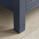 [Blue] Linra 4-drawer chest angled close-up of painted frame leg base corner showing beaded panel door detail