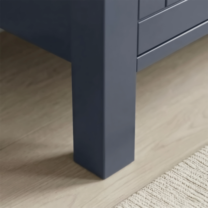 [Blue] Linra 4-drawer chest angled close-up of painted frame leg base corner showing beaded panel door detail