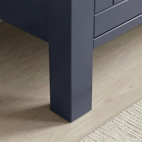 [Blue] Linra 4-drawer chest angled close-up of painted frame leg base corner showing beaded panel door detail
