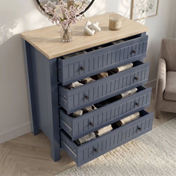[Blue] Linra 4-drawer chest with drawers open showing interior depth and accessories arranged on oak veneer top