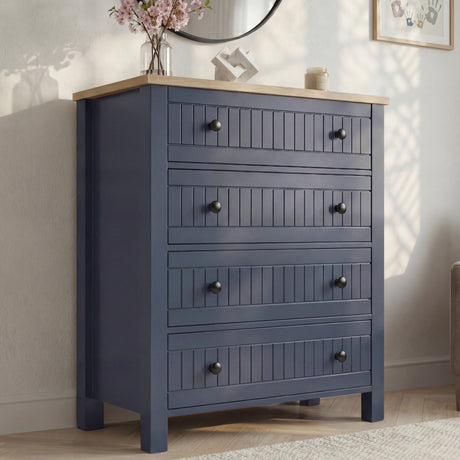 [Blue] Linra 4-drawer chest side angled view showing full height in a styled bedroom with mirror and books on top