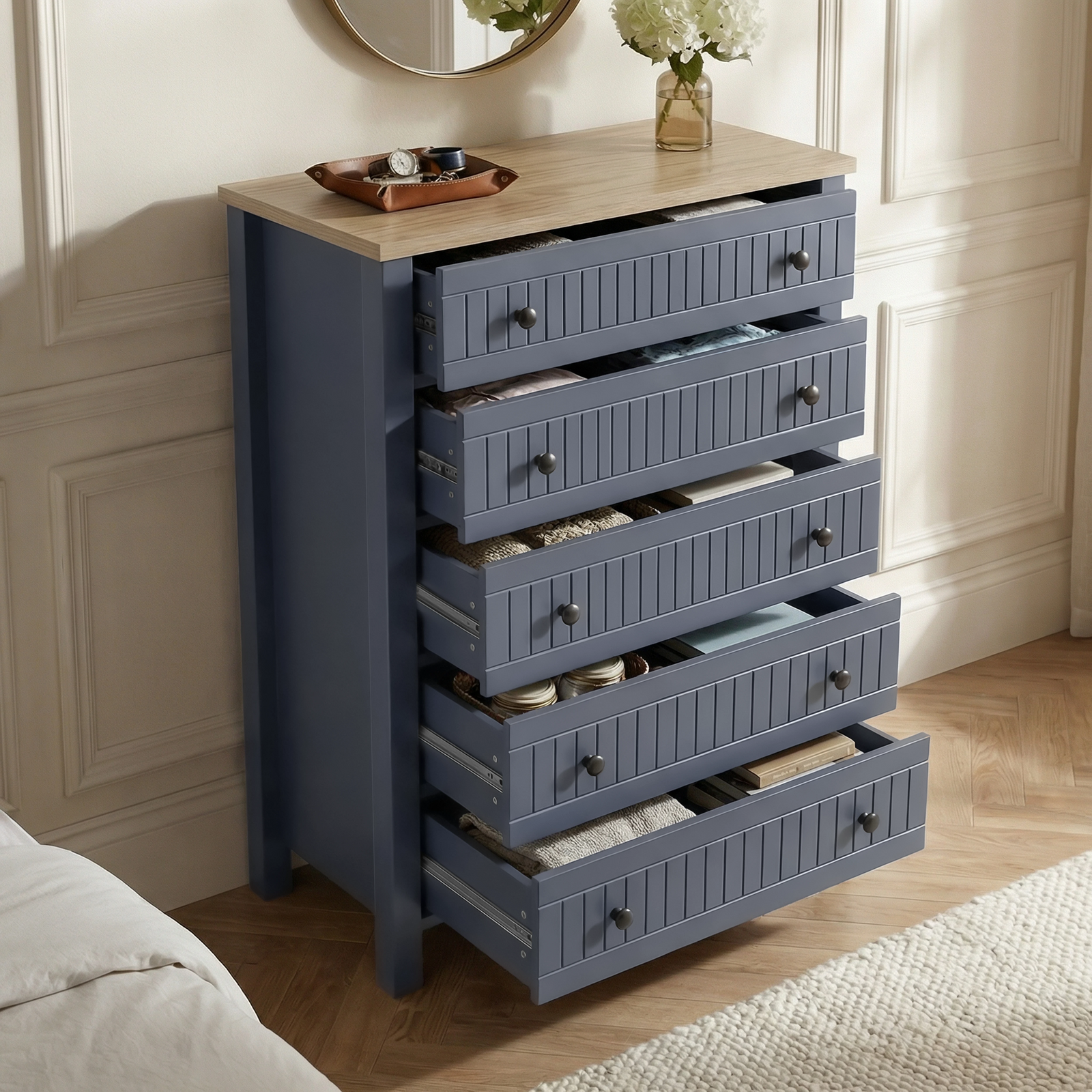 [Blue] Linra 5-drawer chest with drawers open showing interior depth and accessories arranged on oak veneer top