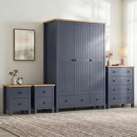 [Blue] Linra bedroom set full room lifestyle view with wardrobe, chest and bedside tables in a styled bedroom