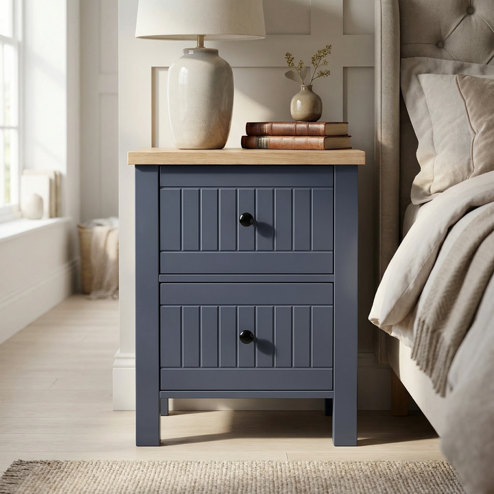 [Blue] nightstand with wooden top next to a bed in a bedroom setting