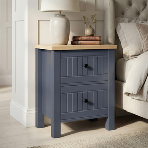 [Blue] Linra 2-drawer bedside table side view on plain background showing painted frame depth and oak top