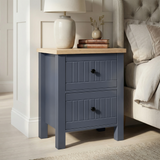 [Blue] Linra 2-drawer bedside table side view on plain background showing lamp, books, frame depth and oak top