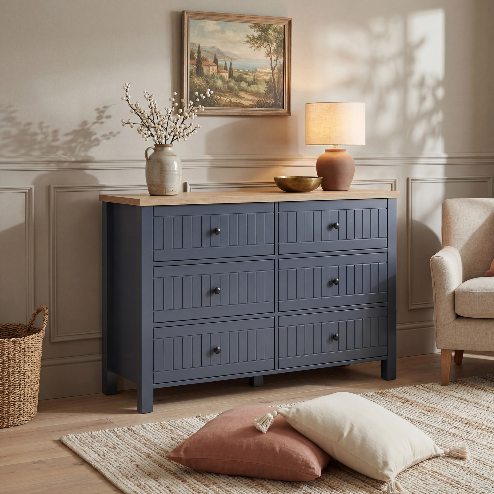 [Blue] Linra large 6 drawer chest in lifestyle setting with cream armchair, basket and landscape art