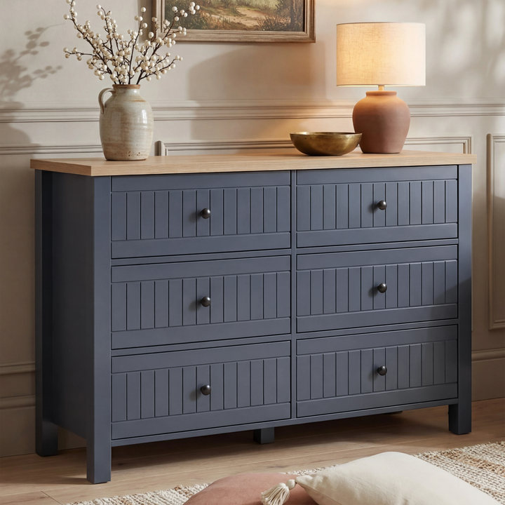 [Blue] Linra large 6 drawer chest front view with stoneware vase, brass bowl and terracotta lamp on oak top