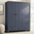 [Blue] Linra wardrobe in blue with three closed grooved doors, oak top, two base drawers, and brass knobs