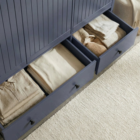 [Blue] Linra wardrobe base drawer pulled open at an angle showing large storage space with folded garments inside