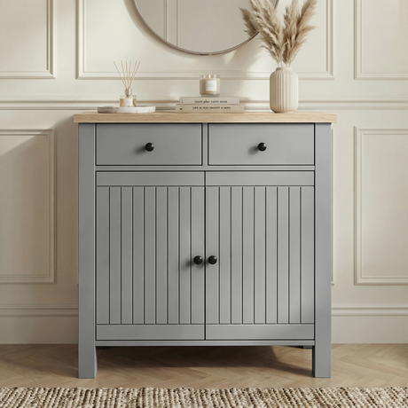 [Grey] Linra grey 2 door sideboard with drawers shown front-on in a neutral lounge with oak veneer top