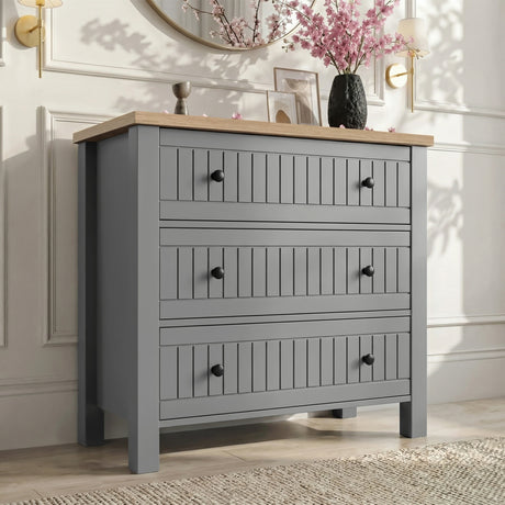 [Grey] Linra 3-drawer chest main front view with vase and decorative objects arranged on oak veneer top
