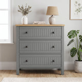 [Grey] Linra 3-drawer chest front view in a styled room with round mirror and decorative objects on oak veneer top
