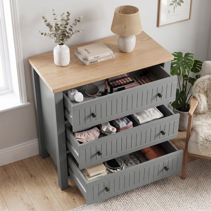 [Grey] Linra 3-drawer chest with all drawers open showing interior storage depth with feature annotation overlay