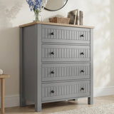 [Grey] Linra 4-drawer chest front view in a styled room with round mirror, books and vase on oak veneer top