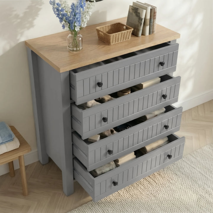 [Grey] Linra 4-drawer chest with drawers open in a styled room showing interior depth and accessories on oak top