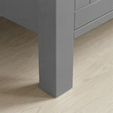 Linra 4-drawer chest close-up of one tapered square painted leg standing on light oak laminate floor