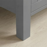 Linra 4-drawer chest close-up of one tapered square painted leg standing on light oak laminate floor