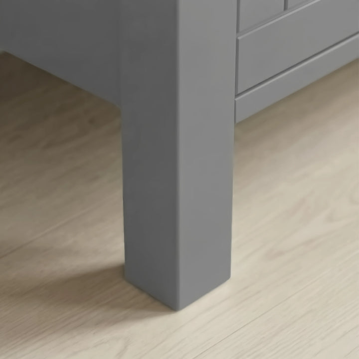 Linra 4-drawer chest close-up of one tapered square painted leg standing on light oak laminate floor