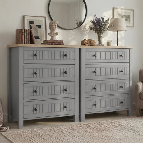 [Grey] Linra 4-drawer chest in a wider bedroom lifestyle shot with round mirror, books and accessories on oak top