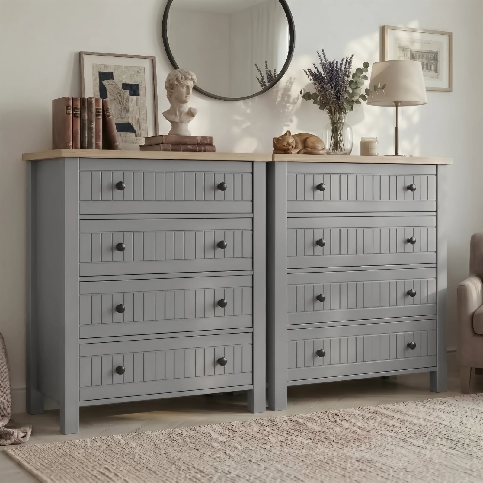 Two Linra 4-drawer chests placed side by side under round mirror with bust sculpture and lamp on oak tops
