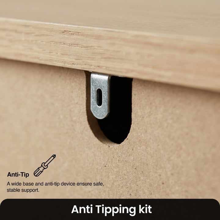 [Grey] Linra 5-drawer chest detail showing anti-tip wall safety bracket and oak veneer top edge close-up