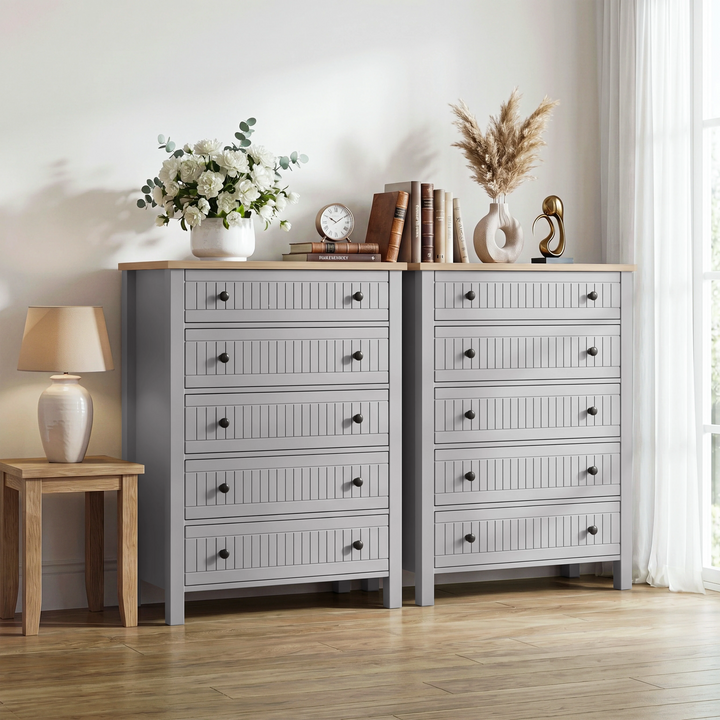 [Grey] Linra tall chest of drawers shown as a pair side by side with roses, books, clock and pampas vase