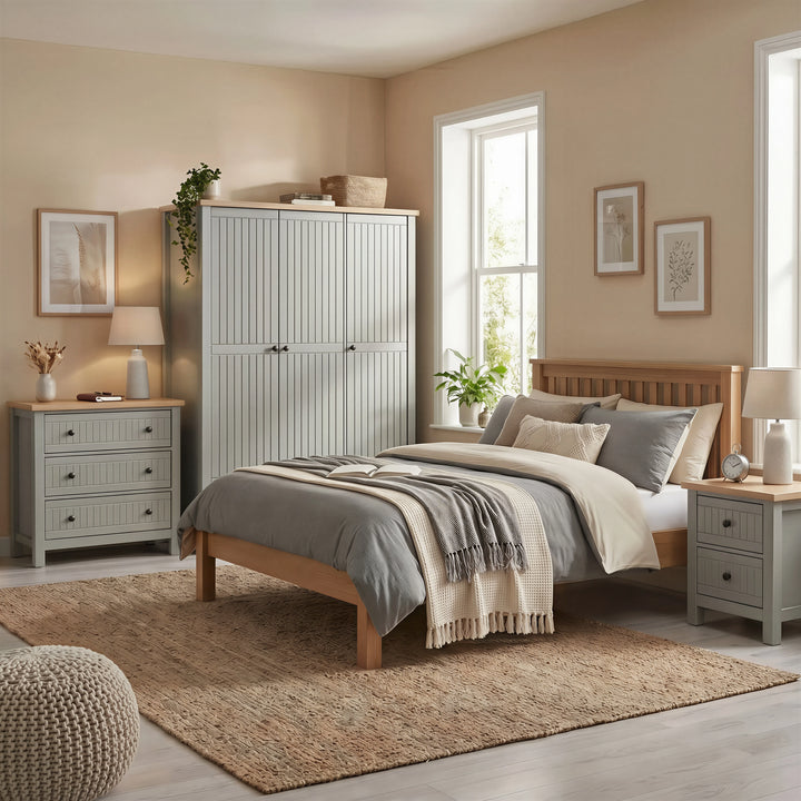 [Grey] Linra Painted 4 Piece Bedroom Furniture Set Grey arranged beautifully in a sunlit bedroom with a wooden bed frame.