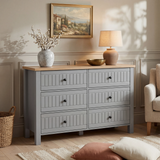 [Grey] Linra large 6 drawer chest in bedroom lifestyle setting with armchair, lamp and framed artwork