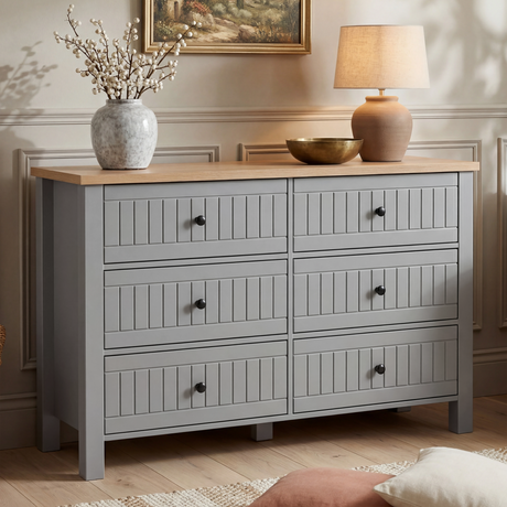 [Grey] Linra 6-drawer chest main front view with vase and lamp on oak top and framed artwork on the wall above