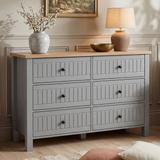 [Grey] Linra large 6 drawer chest front view with vase and table lamp on oak top with framed artwork above