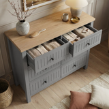 [Grey] Linra 6-drawer chest with top drawer open showing interior depth and accessories arranged on oak veneer top