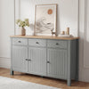 [Grey] Linra 135cm sideboard front view in a styled room with framed artwork and decorative objects on oak top