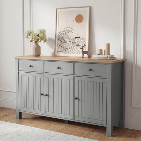 [Grey] Linra 135cm sideboard front view in a styled room with framed artwork and decorative objects on oak top