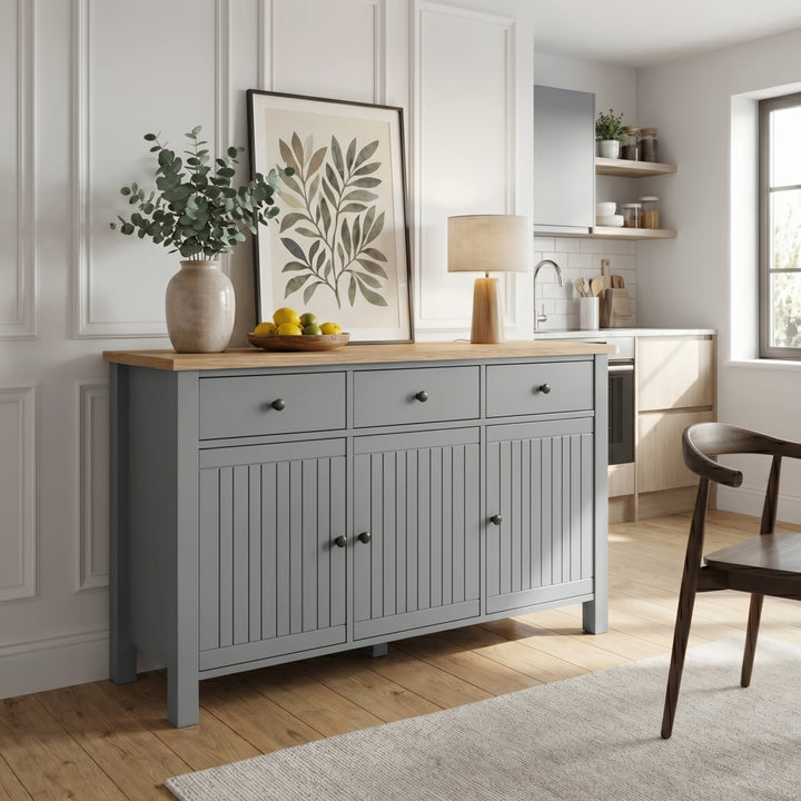 Linra grey sideboard in open-plan kitchen with white cabinetry, open shelving and dark dining chair to the right