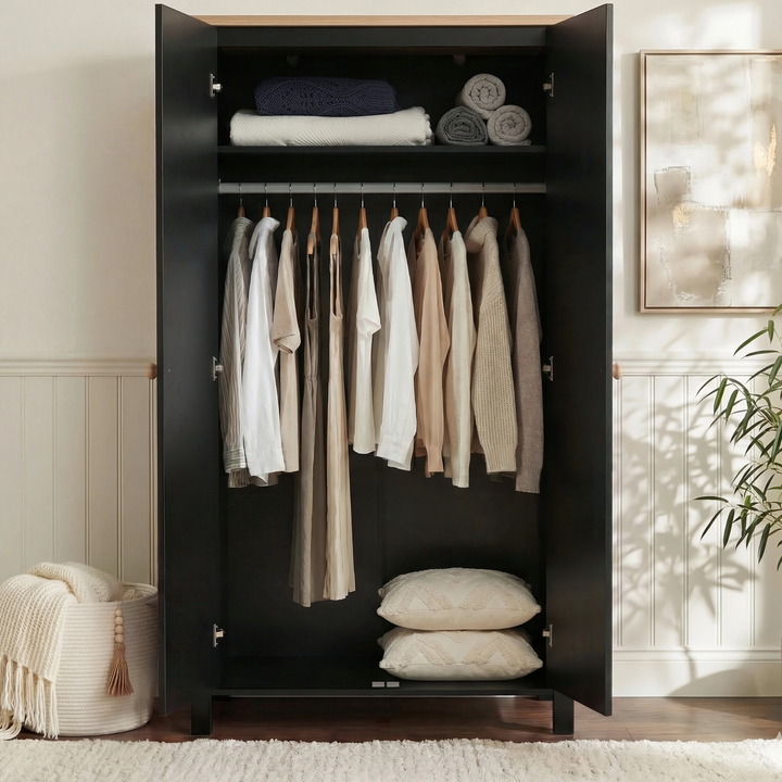 [Black] Interior of Linra 2 door wardrobe with folded linens on shelf and hanging rail of garments