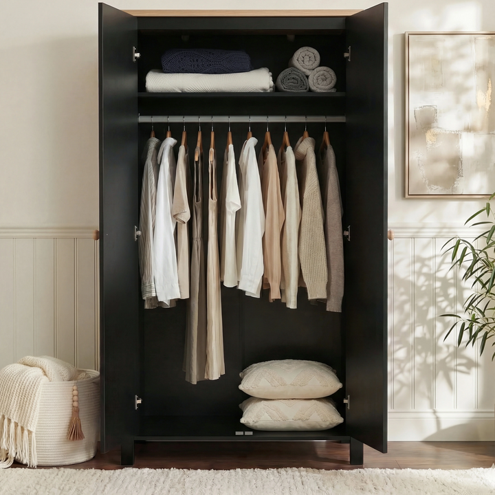 [Black] Interior of Linra 2 door wardrobe with folded linens on shelf and hanging rail of garments