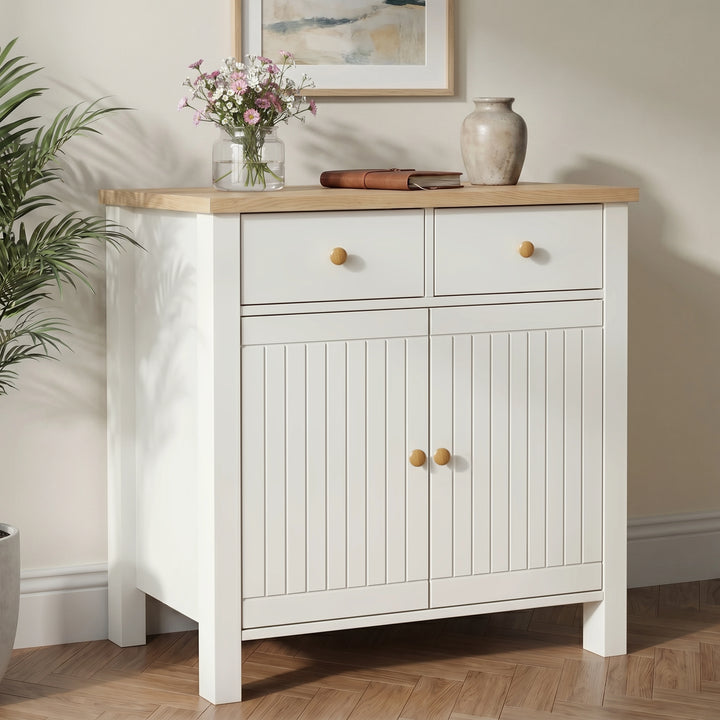 [White] Linra sideboard in a hallway living space styled with ceramic lamp, decorative vases, stacked books, and gallery wall artwork