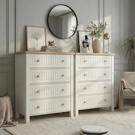 [White] Linra 4-drawer chest in a wider bedroom lifestyle shot with round mirror, plant and accessories on oak top