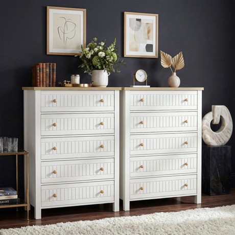 [White] Linra 5-drawer chest in a wider lifestyle setting with dark wall, books and accessories on oak veneer top